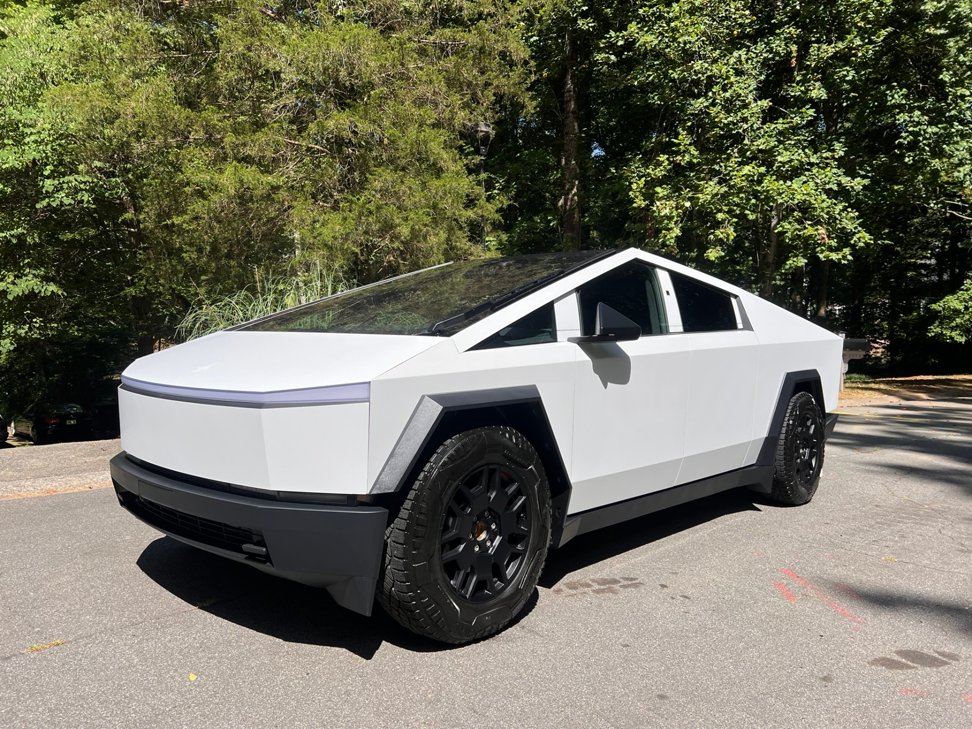 White Tesla Cybertruck parked outdoors after detailing and protection work.